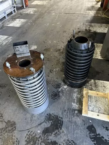 Comparison of failed and new boiler coil from industrial hot pressure washer during emergency repair in Atherstone.
